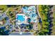 Overhead aerial view of a community pool and playground, with lush landscaping and mature trees surrounding it at 128 Fulbourn Pl., Myrtle Beach, SC 29579