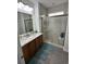 Bright bathroom featuring a double vanity, large mirror, and glass enclosed tiled shower with a built-in bench at 128 Fulbourn Pl., Myrtle Beach, SC 29579