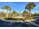 Beautiful clubhouse entrance with palm trees, a decorative fountain, and lush landscaping at 128 Fulbourn Pl., Myrtle Beach, SC 29579