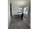 Dining area with marble table, chandelier, and views of both the kitchen and entryway at 128 Fulbourn Pl., Myrtle Beach, SC 29579