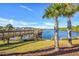 A wooden dock extends over a serene lake, inviting peaceful strolls and scenic views of neighborhood at 128 Fulbourn Pl., Myrtle Beach, SC 29579