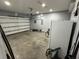 Spacious garage with ample storage space, featuring a garage door and various household items at 128 Fulbourn Pl., Myrtle Beach, SC 29579