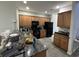 Functional kitchen with wood cabinetry, granite countertops and black appliances providing plenty of space at 128 Fulbourn Pl., Myrtle Beach, SC 29579