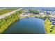 Scenic lake view with the community pool and clubhouse nestled among the trees at 128 Fulbourn Pl., Myrtle Beach, SC 29579