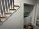 Convenient laundry area with a washer, dryer, and storage cabinets, located near the staircase at 128 Fulbourn Pl., Myrtle Beach, SC 29579