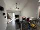 Bright living room with cathedral ceiling, tiled floors, view to the kitchen, and sliding doors to patio at 128 Fulbourn Pl., Myrtle Beach, SC 29579