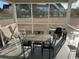 Relaxing screened-in porch with outdoor seating, perfect for enjoying the surrounding views at 128 Fulbourn Pl., Myrtle Beach, SC 29579