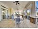 Spacious covered patio featuring stone columns, tiled flooring, multiple tables with chairs, and ceiling fans at 128 Fulbourn Pl., Myrtle Beach, SC 29579