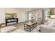 Modern living room with wood-look flooring, stylish seating, and natural light at 218 Carver Willow Dr., Loris, SC 29569