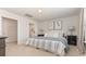 Bright main bedroom with neutral decor, a large bed, and an ensuite bathroom at 218 Carver Willow Dr., Loris, SC 29569