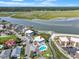 Aerial view of condo with pool alongside the marsh and inlet at 300 63Rd Ave. N # 306-C, North Myrtle Beach, SC 29582
