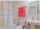 Well-lit bathroom featuring a bathtub, patterned shower curtain, and sink at 300 63Rd Ave. N # 306-C, North Myrtle Beach, SC 29582