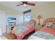 Bedroom with two twin beds, TV, a ceiling fan and wooden floors at 300 63Rd Ave. N # 306-C, North Myrtle Beach, SC 29582
