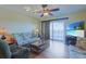 Comfortable living room with stylish furnishings, hardwood floors, and balcony access at 300 63Rd Ave. N # 306-C, North Myrtle Beach, SC 29582