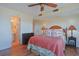 Cozy main bedroom showcasing hardwood floors, lamps, and an ensuite bathroom at 300 63Rd Ave. N # 306-C, North Myrtle Beach, SC 29582