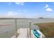 Personal pier featuring a kayak for serene inlet adventures at 300 63Rd Ave. N # 306-C, North Myrtle Beach, SC 29582
