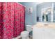 Clean bathroom with floral shower curtain and white vanity at 4648 Livorn Loop # 2628, Myrtle Beach, SC 29579