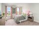 Bright bedroom with a floral quilt, a pink headboard, two windows and soft pink curtains at 531 Slaty Dr., Myrtle Beach, SC 29588