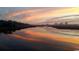 Sunrise over a waterway, reflecting vibrant pink and orange hues in the tranquil water at 562 Haven View Way, Murrells Inlet, SC 29576