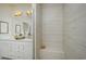 Elegant bathroom with luxurious tile shower, double vanity with gold fixtures and lighting at 8476 Duke Pl. # 32, Myrtle Beach, SC 29572