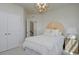 Sunburst headboard and modern light fixture create an elegant and comforting space in this bedroom at 8476 Duke Pl. # 32, Myrtle Beach, SC 29572