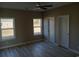 Bright bedroom with ceiling fan, hardwood floors and multiple windows at 941 Hickman Rd., Tabor City, NC 28463