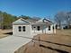 Newly constructed home with gray siding, a covered porch, and a concrete driveway at 941 Hickman Rd., Tabor City, NC 28463