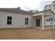 Tan vinyl sided home with covered patio, and sliding glass door at 1050 Harbor Dr., Calabash, NC 28467