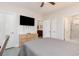Inviting bedroom features ensuite bath, tv, closet, and stylish furniture at 109 S Shore Blvd. # 104, Longs, SC 29568