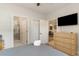 Bright bedroom with ensuite bathroom, featuring a large TV and hardwood flooring at 109 S Shore Blvd. # 104, Longs, SC 29568