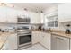 Well-lit kitchen featuring stainless steel appliances, granite countertops, and white cabinets at 109 S Shore Blvd. # 104, Longs, SC 29568