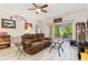 Cozy living room featuring a plush sofa, ceiling fan, and sliding glass doors to the outside patio at 109 S Shore Blvd. # 104, Longs, SC 29568