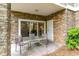 Covered patio with stone walls and outdoor seating, ideal for relaxing at 109 S Shore Blvd. # 104, Longs, SC 29568
