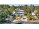 Elevated view of charming two-story home with driveway and lush landscaping at 112 Cockle Shell Ct., Pawleys Island, SC 29585