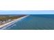 Aerial view of beach, ocean, and shoreline homes at 112 Cockle Shell Ct., Pawleys Island, SC 29585