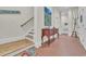 Spacious basement hallway with brick flooring and staircase at 112 Cockle Shell Ct., Pawleys Island, SC 29585