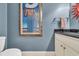Powder room with dark vanity and framed artwork at 112 Cockle Shell Ct., Pawleys Island, SC 29585
