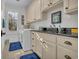 Bright laundry room with washer, dryer, and ample cabinetry at 112 Cockle Shell Ct., Pawleys Island, SC 29585