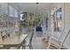 Screened porch with wooden flooring and string lights at 112 Cockle Shell Ct., Pawleys Island, SC 29585