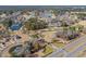 An aerial view of a golf course community featuring houses, water features, and a manicured landscape at 1151 Bear Lake Dr., Longs, SC 29568