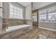 Bright bathroom featuring a soaking tub and a glass-enclosed shower at 1151 Bear Lake Dr., Longs, SC 29568