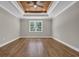 Bright, airy bedroom with wood tray ceiling and hardwood floors at 1151 Bear Lake Dr., Longs, SC 29568