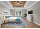 Cozy bedroom with a wood tray ceiling, large bed, and stylish decor at 1151 Bear Lake Dr., Longs, SC 29568