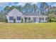 Charming white brick home with inviting front porch and well-manicured landscaping at 1151 Bear Lake Dr., Longs, SC 29568