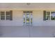 Covered front porch with decorative shutters and painted white brick for increased curb appeal at 1151 Bear Lake Dr., Longs, SC 29568