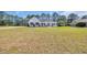 Charming home with white brick and a spacious front yard at 1151 Bear Lake Dr., Longs, SC 29568
