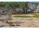 A well maintained putting green is surrounded by mature trees, creating a serene golfing experience at 1151 Bear Lake Dr., Longs, SC 29568