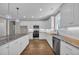 Bright kitchen features granite countertops, stainless steel appliances, and ample white cabinet space at 1151 Bear Lake Dr., Longs, SC 29568