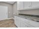 Laundry room with custom cabinets and a granite countertop at 1151 Bear Lake Dr., Longs, SC 29568