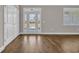 Bright living room area featuring new laminate flooring, a double door closet, and a window at 1151 Bear Lake Dr., Longs, SC 29568